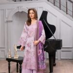 Model wearing lavender dhanak suit with digital print, embroidery and floral wool shawl by Munira Designers