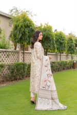 Side view of cream floral printed dhanak suit with leaf-print wool shawl and ikat border, Lubna Dhanak Vol 15 by Munira Designers