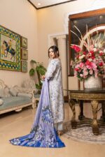 Side view of Lubna Dhanak Vol. 15 ice blue floral dhanak suit with long lavender and royal blue printed wool shawl by Munira Designers