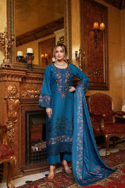 Woman wearing Mahi teal blue Dhanak suit with floral embroidery and printed wool shawl