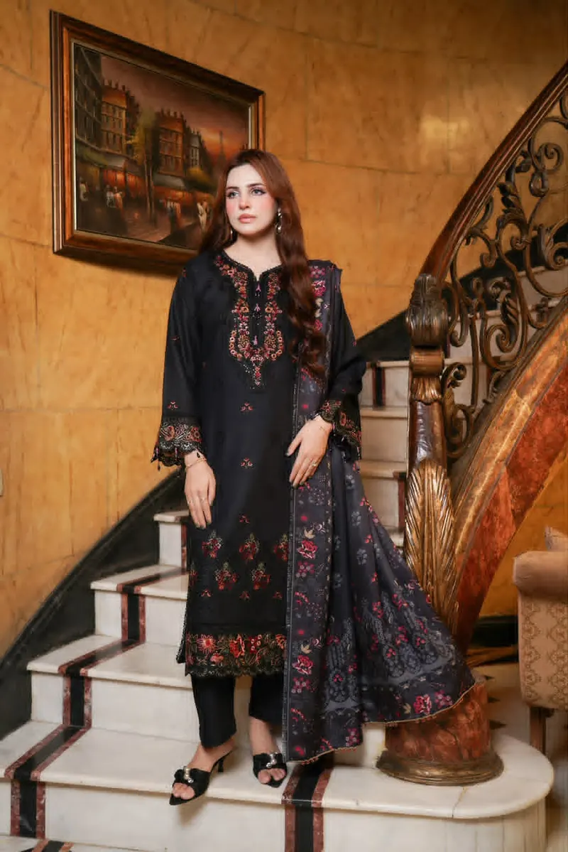 munira-mahi-vol-18-black-embroidered-dhanak-suit-front Black embroidered Dhanak suit with floral embroidery on the neckline, sleeves, and hem, paired with black trousers and a printed shawl.