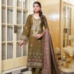 Woman wearing Mahi olive green Dhanak suit with floral embroidery and printed wool shawl